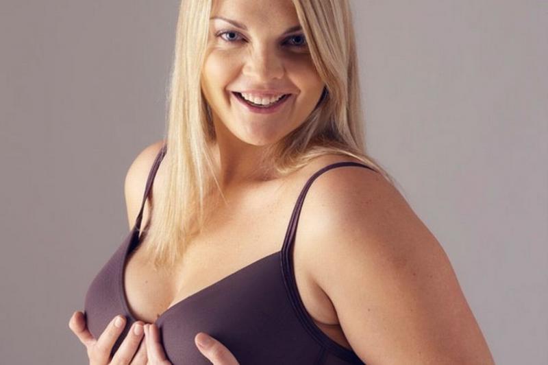 Young-woman-wearing-bra-hands-on-breasts-smiling-portrait.jpg